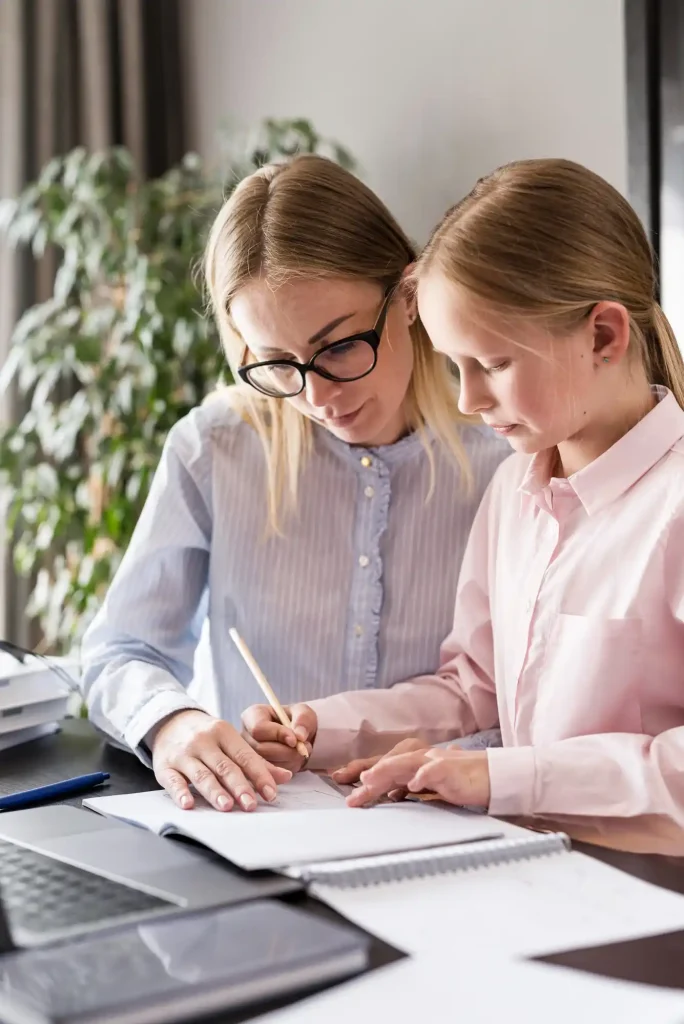 Tutor helping a student write during a one on one lesson